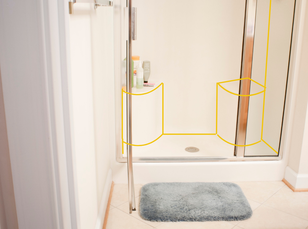 This is a shower with a door and it has one large step up into the shower and two small corner seats. You can see one seat is being used as a shelf for bathing supplies.